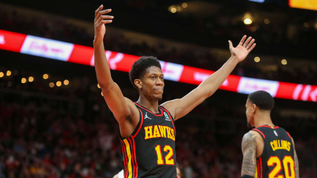 De'Andre Hunter holds his hands in the air.